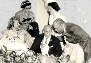 A picture of Father Divine's attorney, J. Austin Norris, at right, speaking to Divine during a banquet, to illustrate a blog post about Divine's Civil Rights work. | Father's Kingdom 